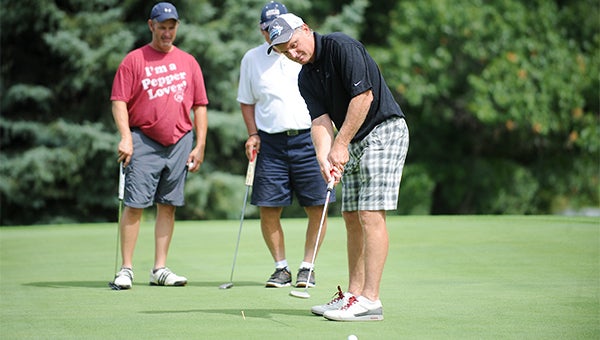 Steve Cerrato putts Saturday during the Albert Lea Hockey Open. Cerrato played in the same group as his former high school hockey coach, Roy Nystrom. Cerato played for Nystrom from 1976 to 1978. View a gallery of photos at AlbertLeaTribune.com. — Micah Bader/Albert Lea Tribune