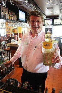 David Mord, manager of the Green Mill Restaurant in Albert Lea, holds up a drink called the CoronaRita. 