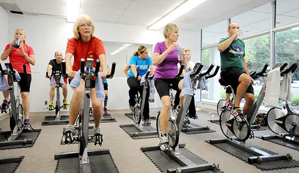 Members of a spinning class taught by Destiny Smith continue peddling at the Albert Lea Family Y on its 100th anniversary, which was July 24.
