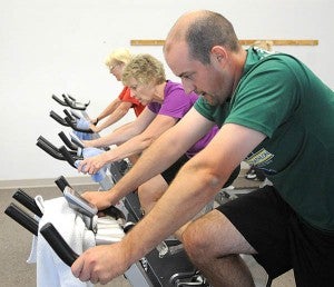 Spinning students get a workout on Keiser M3 stationary bikes at the Albert Lea Family Y. From right are Mark Heinemann, JoAnn Bracker and Vikki Pence. 