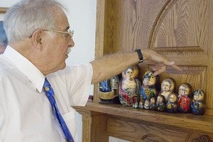 Milt Ost shows off a matryoshka doll collection featuring faces of the Russian monarchy. – Hannah Dillon/Albert Lea Tribune