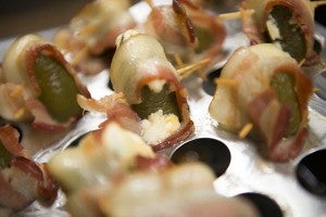 Tribune graphic designer Kristin Overland made up some jalapeno poppers with jalepenos fresh from her garden, stuffed with cream cheese and shredded cheese and wrapped in bacon. — Colleen Harrison/Albert Lea Tribune