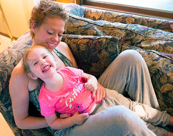 Katy Zuehl holds her 2 year-old daughter, Parker Lund. Zuehl, now 32, was diagnosed with invasive ductal carcinoma — a form of breast cancer — almost one year ago. — Colleen Harrison/Albert Lea Tribune