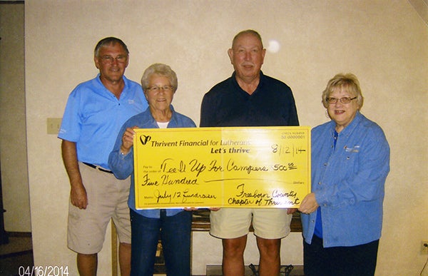 Freeborn County Chapter of Thrivent Financial board members Nancy Verhey and Virginia Boettcher present a check for $500 supplemental funding from Thrivent Financial to Al Jensen and Jim Beach for their Tee It Up for Campers fundraiser July 12. – Provided