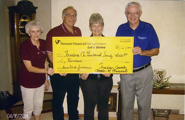 Freeborn County Chapter of Thrivent Financial board members Joyce Fredin, Garry Hunnicutt and Neil Pierce present a check of $600 supplemental funding from Thrivent Financial to Pat Mulso of the Freeborn County Historical Society for their Swiss steak fundraiser July 24. – Provided