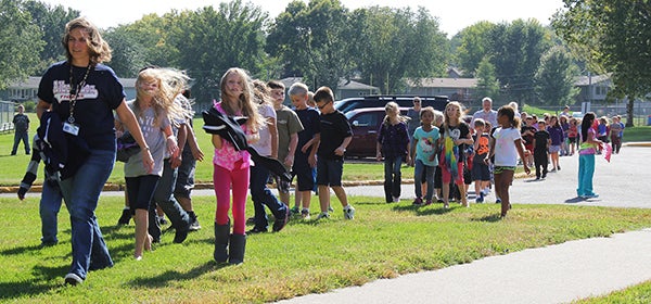 The wind blows strongly as students walk across the shared campus of Sibley Elementary School and Southwest Middle School on Friday. — Tim Engstrom/Albert Lea Tribune