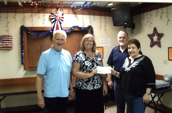 The Eagles Club donated $500 to Hospice. Hospice director Marcia Smith is shown accepting the check from taco committee members Sid Johnson and Dale and Marcia Johnston. — Provided