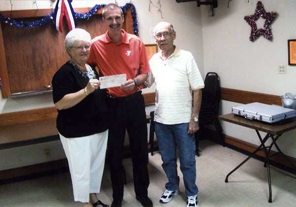 The Eagles Club donated to the Family Y recently. Dennis Dieser is shown accepting the check from taco committee members Kathy Halvarson and Bill Myers. — Provided