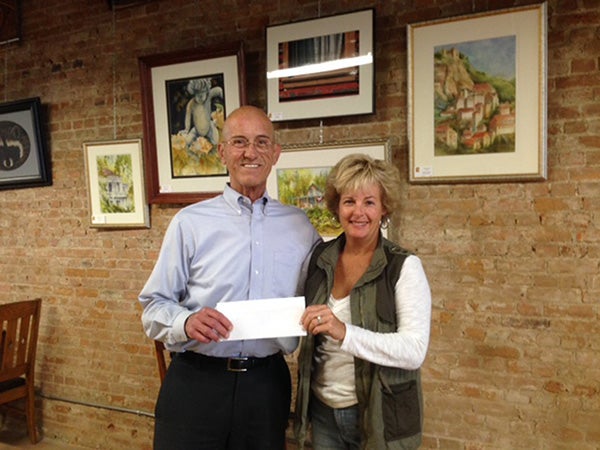 Susie Petersen, trustee of the Albert B. Cuppage Foundation, presents a check to Randy Kehr, representing Albert Lea Chamber Foundation for the School Calendar. Each year the Chamber Foundation and Church Offset Printing prepare the school calendars for the school district at no charge to the district. Not pictured are Henry Savelkoul, Don Savelkoul and Kevin, trustees of the Albert B. Cuppage Foundation. — Provided