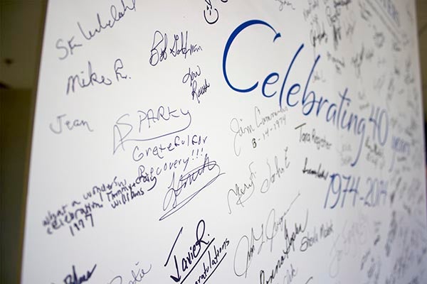 A large banner signed at the facility’s anniversary dinner sits in the Fountain Centers lobby. – Hannah Dillon/Albert Lea Tribune