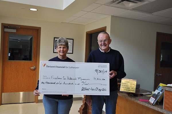 Allen Tullberg, representative for the Albert Lea chapter of Thrivent Financial, presents Pat Mulso, executive director of the Freeborn County Historical Museum, with a check for $1,600 as supplemental funding to their Autumn in the Village fundraiser. – Provided