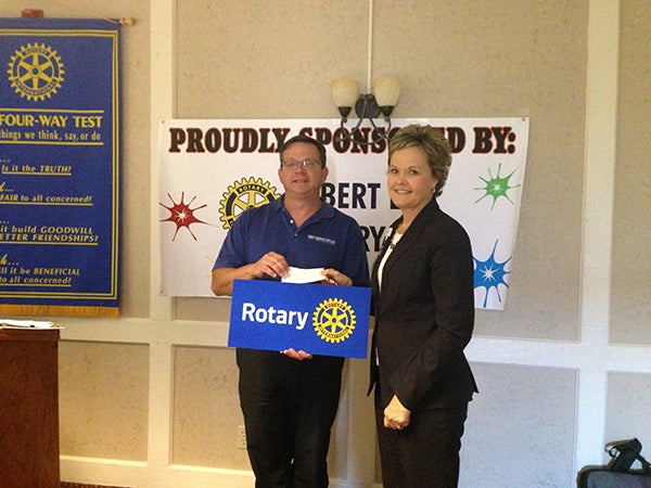 Tricia Dahl, operations administrator at Mayo Clinic Health System of Albert Lea, presents a donation check to Garry Hart, president of the Rotary Club. The Rotary Club of Albert Lea sponsored a UV Splash Color Dash.  Proceeds from the event went to providing healthy snacks benefitting all students at Halverson Elementary School. – Provided