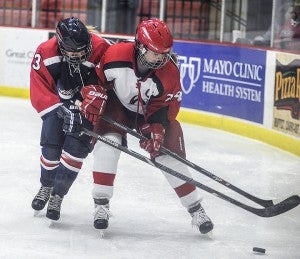 Albert Lea's Sage Kermes battles with Austin's Madison Overby during the first period Thursday night in Austin. — Eric Johnson/Albert Lea Tribune