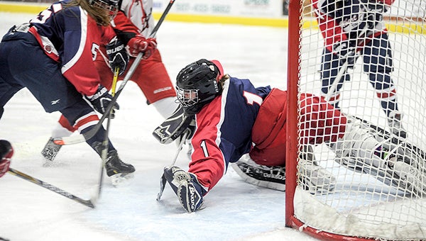 Albert Lea goalie Sky Anderson lunges for the puck during the first period against Austin in Austin Thursday night. —  Eric Johnson/Austin Daily Herald