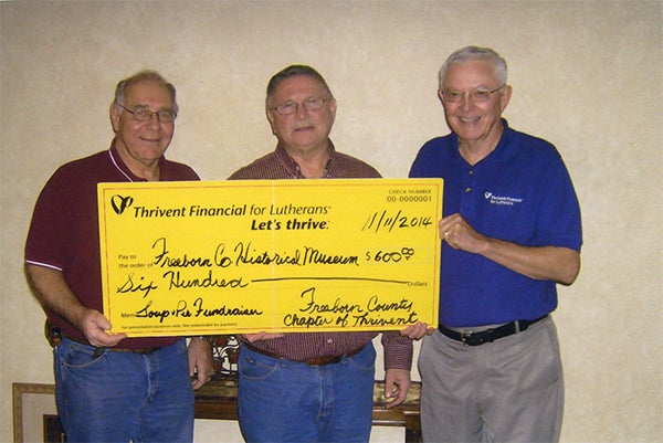 Freeborn County Thrivent board members Gary Hunnicutt and Neil Pierce present a check for $600 in supplemental funding from Thrivent Financial to Dean Johnson for the Freeborn County Historical Museum fundraiser held Sept. 22. — Provided