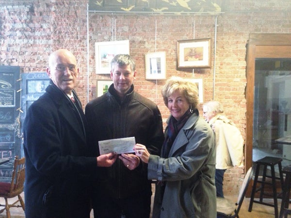 Kevin Dulitz and Susie Petersen, Albert B. Cuppage Foundation trustees, present a check to Randy Kehr, representing the Chamber Foundation for downtown holiday decorations. – Provided