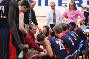 Albert Lea head coach Lucas Kreuscher and assistant coaches Stan Thompson, Chris Withers and Gina Klennert instruct the team during a timeout Saturday against Kasson-Mantorville. – Micah Bader/Albert Lea Tribune