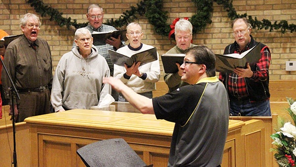 North Mankato resident Jim Wirtz directs the Harmony Junction Barbershop Chorus during practice Tuesday night at the United Methodist Church of Albert Lea. There were 17 men singing, though the entire chorus was not present. They hail from places across the region: Albert Lea, Alden, Geneva, Wells, Freeborn, New Richland, Hartland, Emmons. Kiester and Ellendale. The chorus and the Albert Lea Community Band are set to perform at 3 p.m. Sunday at the United Methodist Church and at 7 p.m. the same day at St. Theodore Catholic Church. – Tim Engstrom/Albert Lea Tribune