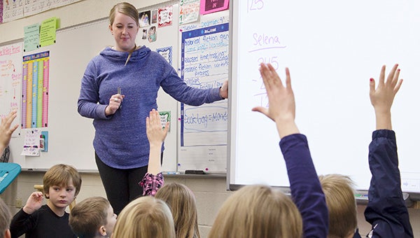 Third-graders in Anna Nordlocken’s class at Lakeview Elementary School raise their hands to tell how they solved a math problem. – Hannah Dillon/Albert Lea Tribune