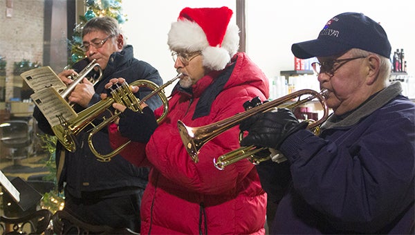 Vern Frydenlund, Steve Weisgram and Ed Nelson of the Albert Lea Community Brass Band perform on Broadway Thursday evening during the Holiday Bazaar on Broadway. – Sarah Stultz/Albert Lea Tribune
