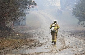A firefighter walks toward a hog barn fire at 85295 290th Street in rural Freeborn County Monday afternoon. Jason Schoonover/Albert Lea Tribune