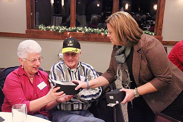Barbara Engebretson of Alliance Benefit Group smiles as Tribune Advertising Director Catherine Buboltz hands her a men’s watch from Fisher’s Fine Jewelers on Tuesday. Engebretson won the watch at the Tribune-sponsored Business After Hours at Wedgewood Cove Golf Course. Business After Hours is a monthly gathering of members with the Albert Lea-Freeborn County Chamber of Commerce. The Belair watch was assembled in the United States, uses Swiss movement and features a sapphire crystal. It has a retail value of $375. – Tim Engstrom/Albert Lea Tribune