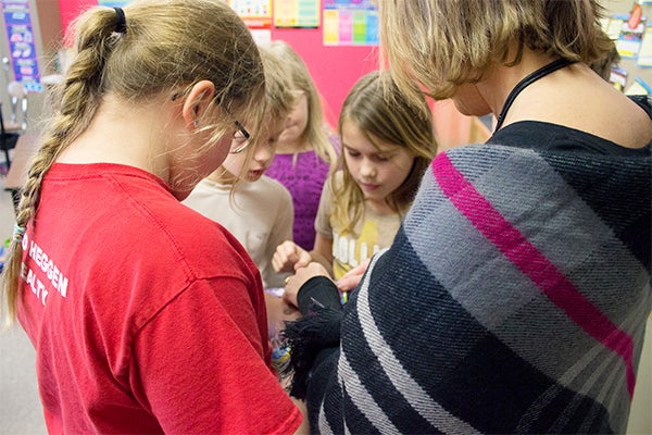 Tracey Magnuson, United South Central School elementary principal, right, picks out candy canes with fourth grade students from Karen Robbins's class during their holiday party. — Hannah Dillon/Albert Lea Tribune