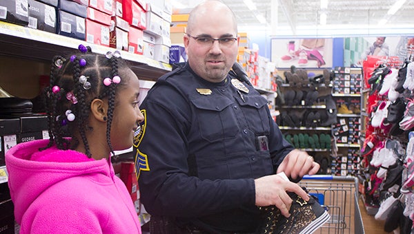 Albert Lea Police Department officer Tim Harves talks with Tyliyah Jolly about shoes in one of the shoe aisles at Walmart on Thursday during Shop with a Cop. Officers and deputies with the Freeborn County Sheriff’s Office were paired up with children from local schools. – Sarah Stultz/Albert Lea Tribune