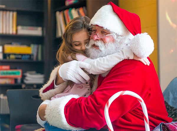 Myla Wright, 5, hugs Santa Claus before visiting with him Dec. 12 at Brookside Education Center. Santa came to visit as a part of the 2014 Winterim "Cookies and Cocoa with Santa" program. — Colleen Harrison/Albert Lea Tribune
