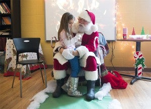Myla Wright visits with Santa Claus during a "Cookies and Cocoa with Santa" program Dec. 12 at Brookside Education Center. — Colleen Harrison/Albert Lea Tribune