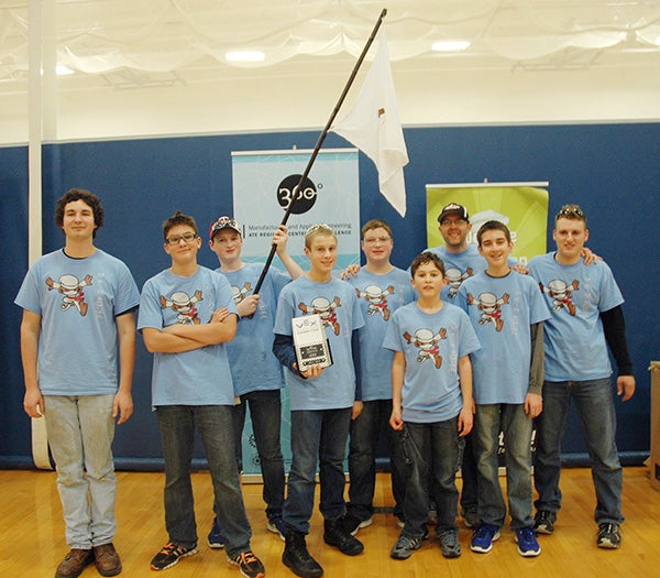 Mysterious George, a robotics team from Austin, won the Judges' Choice Award at the Dream It. Do It. Southern Minnesota VEX Robotics Tournament on Dec. 13. They are shown here holding their team flag, something that helped them get their award. — Provided