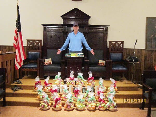 Brian Vairma, newly-elected worshipful master of the Masonic Lodge, poses with fruitbaskets, cookies and mints that get delivered to shut-in brother masons and widows to let them know they are not alone and bring the holiday spirit to them. – Provided
