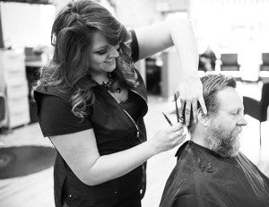 Kalaria Orozco cuts Scott Schroader’s hair at Expressions Salon & Spa in Albert Lea.