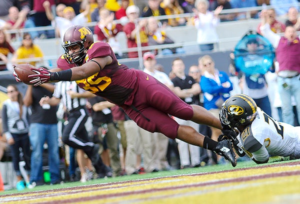 Minnesota running back Rodrick Williams Jr. dives into the end zone for a touchdown in front of Missouri’s Ian Simon during the Buffalo Wild Wings Citrus Bowl at Citrus Bowl Stadium on Thursday in Orlando, Florida. Missouri won 33-17. – Jacob Langston/Orlando Sentinel