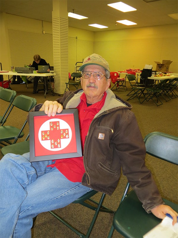 Red Cross blood donor Omer R. Hamer's wife, Maxine, had his previous 20 donor pins framed for him to display. As of the last blood drive, his 168 blood donations have helped save up to 504 lives. — Provided