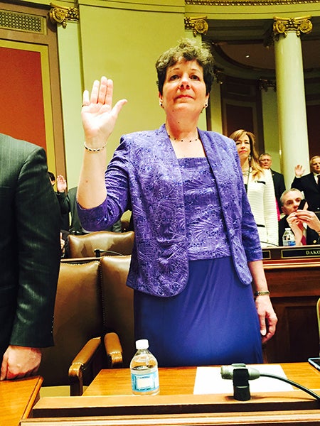 Sibley Elementary School first-grade teacher Peggy Bennett raises her right hand to be sworn in Tuesday at the Minnesota Capitol as the representative for House District 27A. – Provided