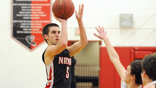 Chad Agrimson of NRHEG shoots over a Blooming Prairie defender Tuesday at New Richland. — Micah Bader/Albert Lea Tribune