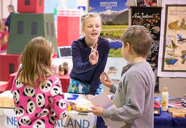 Fifth-grader Gabby Ladlie talks to fellow students about New Zealand during Hollandale Christian School's Festival of Nations Thursday. — Colleen Harrison/Albert Lea Tribune
