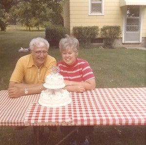 Myron and Betty Young celebrate their 25th anniversary with a cake on the picnic table. The couple celebrated 67 years together before passing away two days apart. - Provided
