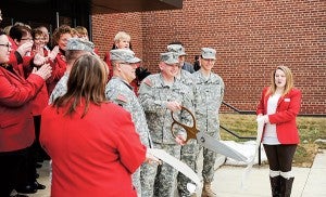 Sgt. 1st Class David Gansen cuts the the ribbon Tuesday afternoon as the National Guard celebrated the reopening of the National Guard Armory in Austin. - Eric Johnson/Albert Lea Tribune