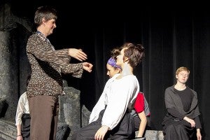 Vocal music teacher Diane Heaney helps actors in the one-act play with a scene where they appear to rise from the dead. - Hannah Dillon/Albert Lea Tribune