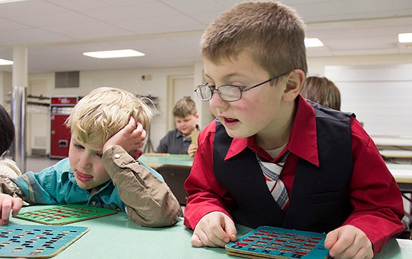 Cayden May, right, and Theodore Bowman search for numbers on their scorecards Wednesday afternoon during a game of bingo at St. Theodore Catholic School. Students this week are celebrating National Catholic Schools Week. - Sarah Stultz/Albert Lea Tribune