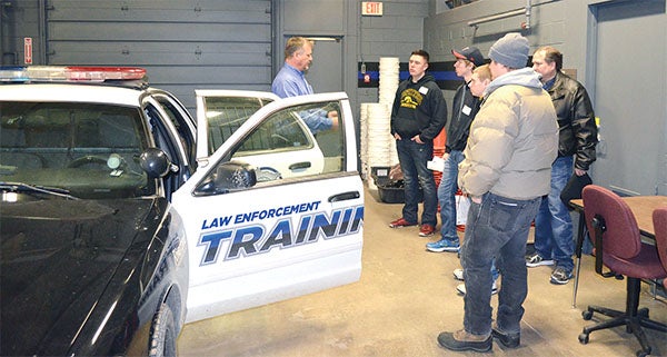 Facility Instructor Rich Watkins shows prospective students the simulation lab and one of the squad cars for the law enforcement program at Riverland Community College in Austin Thursday afternoon. This squad car was donated to Riverland by the Austin Police Department. The short program was part of Riverland's Big Day on Campus, where students get a taste of what attending Riverland College would be like and what the school has to offer. The program is held five times each year. — Jenae Hackensmith/Albert Lea Tribune