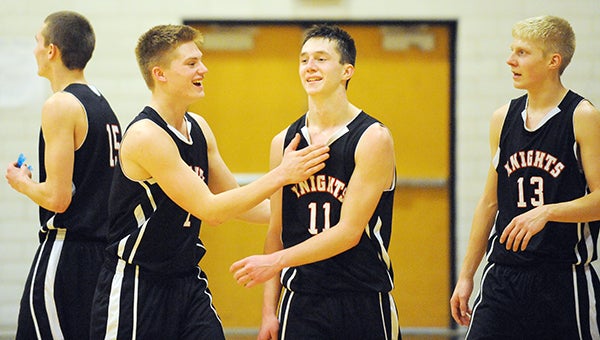 Eli Hallman of Alden-Conger is congratulated by Colton Opsahl, left, and his brother, Jordan Hallman after surpassing 1,000 career points with 1:02 left in the second half Friday against Glenville-Emmons at Alden. — Micah Bader/Albert Lea Tribune
