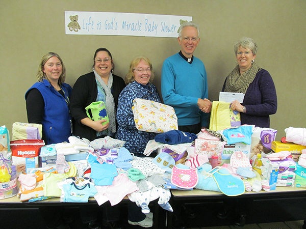 The parishioners of St. Theodore and St. James Catholic churches hosted a “Life is God’s Miracle” baby shower. Pictured, from left, are Natalie Loock, Carol Ganrude, Paulette Beckmann, the Rev. Timothy Reker and Sue Yost. - Provided