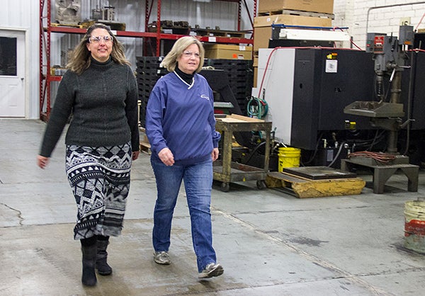 Laura Garza, human relations assistant at Lou-Rich, walks with Cindy Farr, project engineer in early February in the plant. People walk around a path in the plant on their breaks to get some exercise. - Sarah Stultz/Albert Lea Tribune