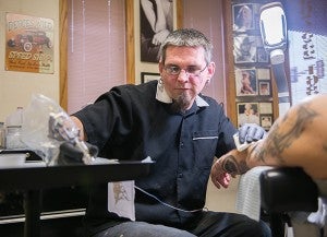 Anson Eklund prepares to tattoo Jeremy Shafer of Austin at Kat’s Tats in Albert Lea. - Colleen Harrison, Albert Lea Tribune