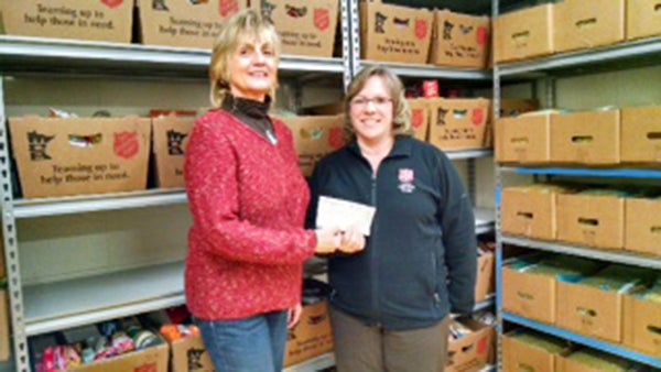 Jody Adams from the Maple Island Park Association presents a check to Kathy Belshan of the local Salvation Army for its food shelf. The local food shelf helps several families every day stretch their groceries by providing items such as vegatables, fruits, soups, crackers and other staples. March was Minnesota FoodShare’s month. Based on donations given last month, pantries could receive a partial grant match that would allow an increase in buying power with the Channel One Food Bank. - Provided