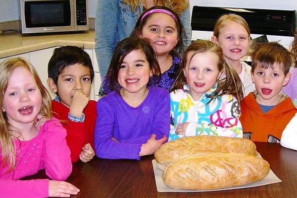 After reading the story “The Little Red Hen,” the kindergarten and preschool classes at St. Casimir’s School in Wells gathered in the school kitchen to make bread. Pictured are some of the bakers, including, from left, Clarissa Schimek, Aaron Pichardo, Julianna Clore, Josie Chavez, Isabella Roberts, Alivia Bruegger and Seth Adams. - Provided
