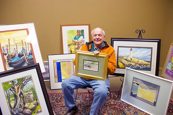 “Have Brush, Will Travel” is an apt name for the James Wegner exhibit at the Albert Lea Art Center from April 14 to May 16. While surrounded by all watercolors in the photo, his exhibit pieces also include pastels, colored inks, prints, collages and acrylics. He is holding “Yangze Fishing Boat,” a scene from China. In the lower left is “Ancient Tree” inspired by a trek to an Aztec ruin in Mexico. In the upper left is “Venice.” Behind him on the floor to the left is “Quarry Spring” and above it “Caribbean Drummer.” In the lower right is “Quarry No. 6” and above right is “Peggy’s Cove,” inspired by a scene from Canada. - Cathy Hay/Albert Lea Tribune